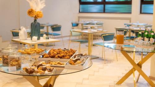 a table filled with different types of pastries on it at Hotel Eden in Toscolano Maderno