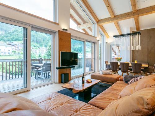 a living room with a couch and a tv at Apart33 Top 1-33 Penthouse in Haus im Ennstal