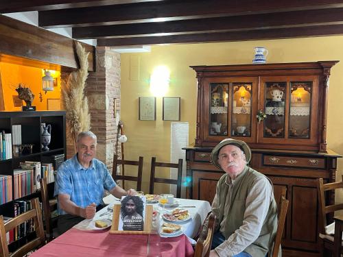 two older men sitting at a table eating food at La Cabala de Ibeas in Ibeas de Juarros