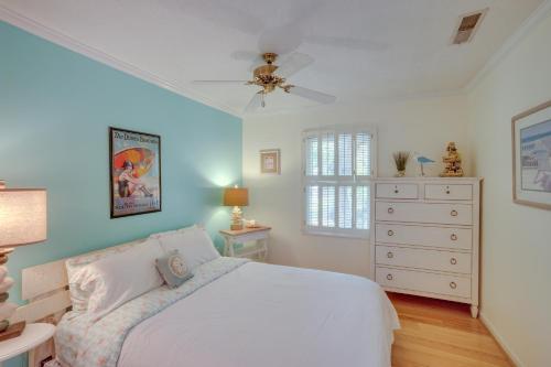 a bedroom with a white bed and a dresser at Near Edisto Beach State Park Home with Lanais! in Edisto Island