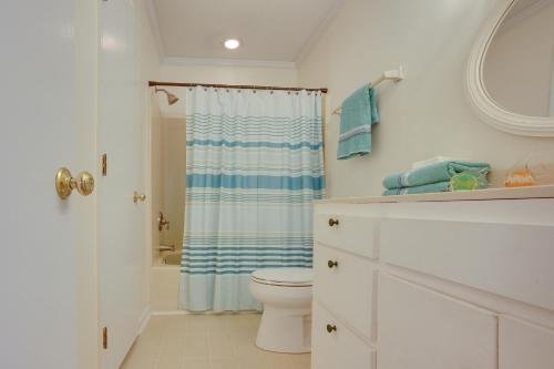 a white bathroom with a toilet and a shower at Near Edisto Beach State Park Home with Lanais! in Edisto Island