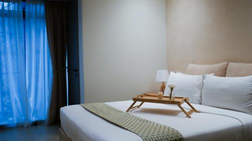a bedroom with a bed with a table on it at Eaton Residence KLCC - KL SUITE in Kuala Lumpur