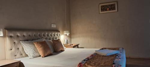 a bedroom with a large bed with white sheets and pillows at Skara Shangara Homestay in Leh