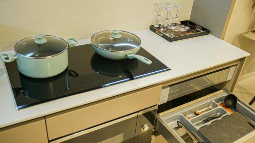 a kitchen counter with two pots on a stove at Eaton Residence KLCC - KL SUITE in Kuala Lumpur