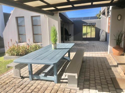 a blue picnic table with a potted plant on a patio at Riverview in Stilbaai