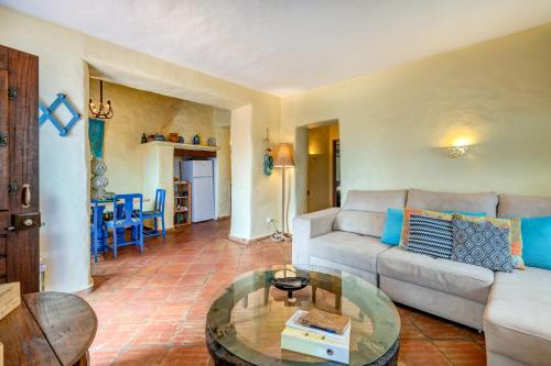 a living room with a couch and a table at Luazinha - Lovingly renovated Fisherman's cottage in Tavira
