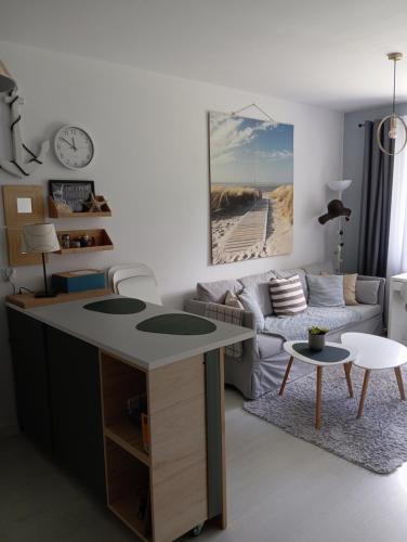 a living room with a table and a couch at Chillout na Wspólnej in Kluki