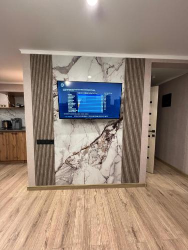 a living room with a wall with a large screen at Гоголя 41 in Karagandy