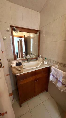 a bathroom with a sink and a mirror at villa dans une ferme écologique in Asilah