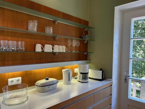 a kitchen with a counter with appliances on it at Ferienwohnung Villa Victoria mit grandiosem Seeblick und Gartennutzung in Jugendstil Villa in Gstadt am Chiemsee