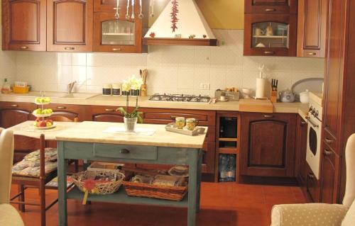 a kitchen with a island in the middle of a kitchen at La Casa Dei Nonni in Massa Martana