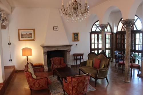 a living room with chairs and a fireplace at Villa Orio Lake Piediluco in Piediluco