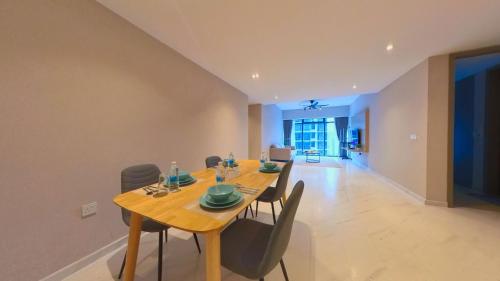 a dining room with a wooden table and chairs at Eaton Residence KLCC - KL SUITE in Kuala Lumpur