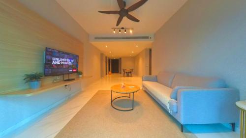 a living room with a couch and a ceiling fan at Eaton Residence KLCC - KL SUITE in Kuala Lumpur
