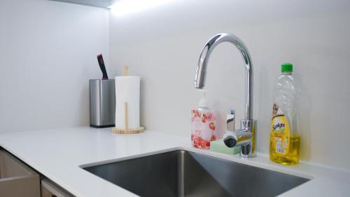 a kitchen counter with a sink in a kitchen at Eaton Residence KLCC - KL SUITE in Kuala Lumpur