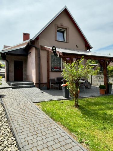 a small house with a porch and a patio at Agroturystyka ‚U Misia’ in Krzywopłoty