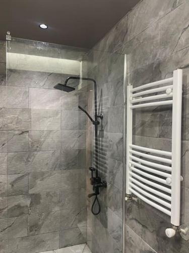 a shower with a glass door in a bathroom at Rue de Paris - Plage Saint Germain - vue sur mer - in Aïn El Turk