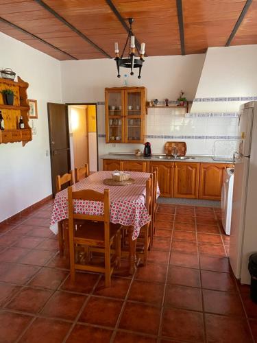 a kitchen with a table and chairs in a room at Villa Toliso in Alora