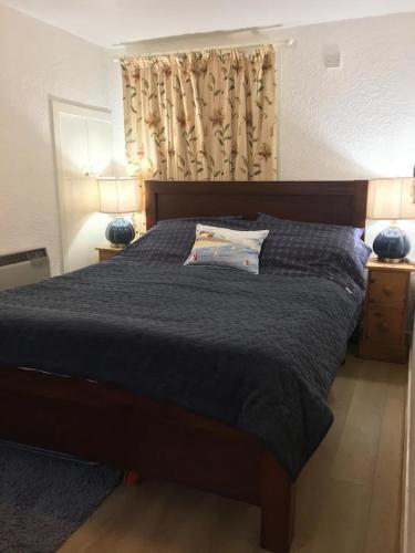 a bedroom with a bed with a black comforter at 105 Seatown in Cullen