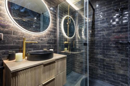 a bathroom with a sink and a glass shower at Villa Close Port Nature in Cap d'Agde