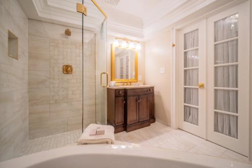 a bathroom with a tub and a shower and a sink at Red Coach Inn in Niagara Falls