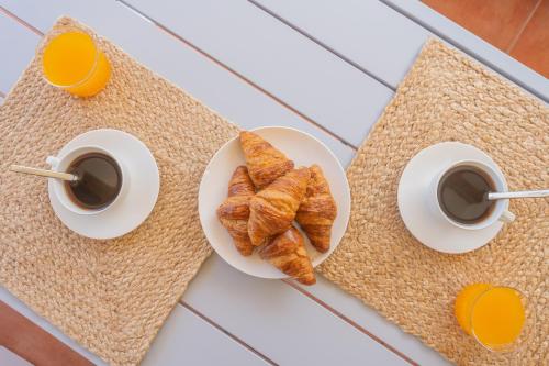 two cups of coffee and croissants on a table at Retiro Sol - Casa Joni in Orba