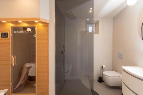 a bathroom with a shower and a toilet at Heritage House Kaleta in Hvar