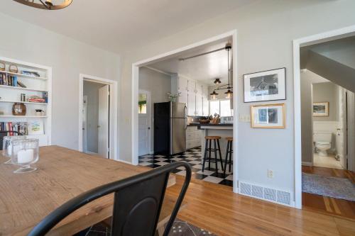 a kitchen and dining room with a wooden table and a dining room at 7th Street Bungalow in Livingston