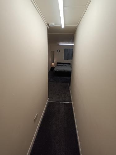a hallway of a room with a bed in the distance at Marsh road in Luton