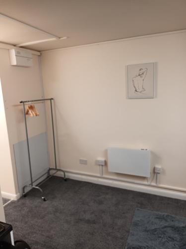 a room with a white wall with a picture on the wall at Marsh road in Luton