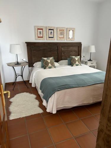 a bedroom with a large bed and two night stands at Casa Vereda del Risco in Ye