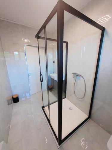 a glass shower in a bathroom with a sink at Villa Sea level with BEAUTIFUL VIEW, Medveja in Lovran