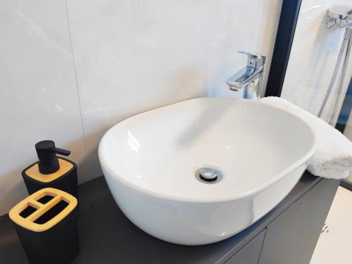a white sink in a bathroom with a mirror at Villa Sea level with BEAUTIFUL VIEW, Medveja in Lovran