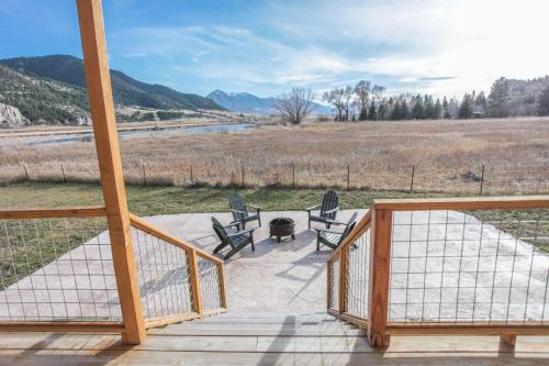 a porch with two chairs and a table and a grill at Evergreen in Livingston