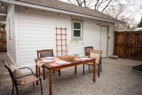 a wooden table and chairs on a patio at West Clark Getaway in Livingston