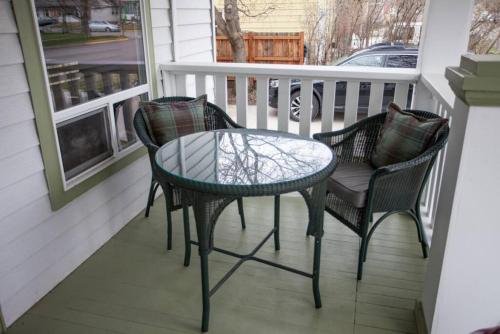 a patio with two chairs and a table on a porch at West Clark Getaway in Livingston
