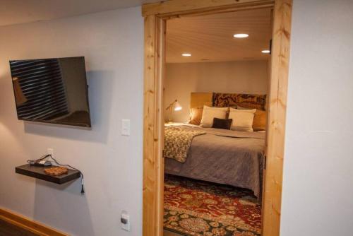 a bedroom with a bed and a large mirror at West Clark Getaway in Livingston