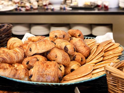 a pile of pastries on a plate on a table at Radisson Blu Hotel Marseille Vieux Port in Marseille