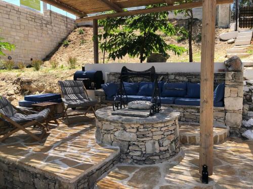 a patio with a blue couch on a stone wall at Villa Antonia in Almirida