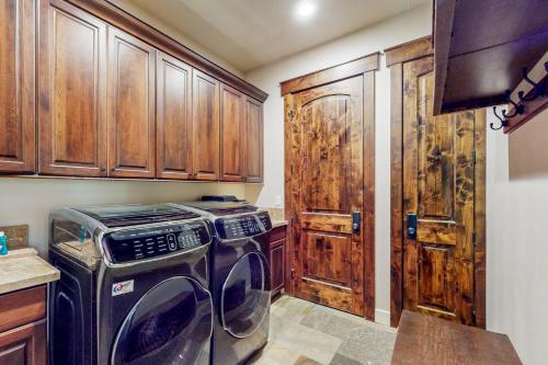 a kitchen with a washer and dryer and wooden cabinets at Cochise Charms in South Lake Tahoe