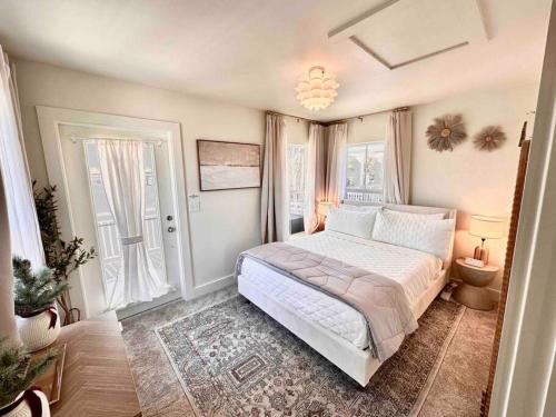 a bedroom with a large bed and a window at Stylish Cozy Family Cottage with Golf Cart - 1 mile to Dwntn Ocean Springs and beach in Ocean Springs