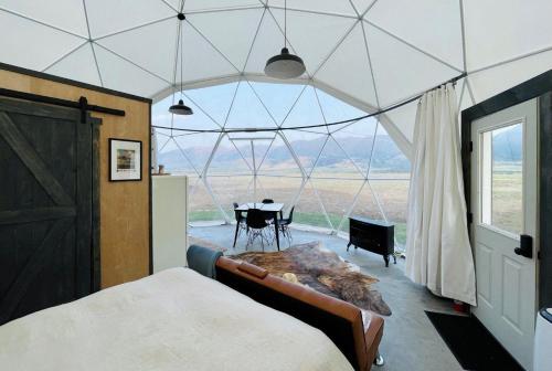 a room with a bed and a table in a tent at Dome #1 in Livingston
