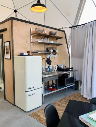 a kitchen with a white refrigerator in a room at Dome #2 in Livingston