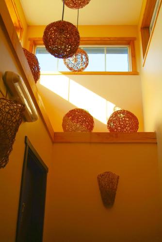 a room with a staircase with a window and some pots at Casa Kalfu Hotel Boutique in Puerto Varas