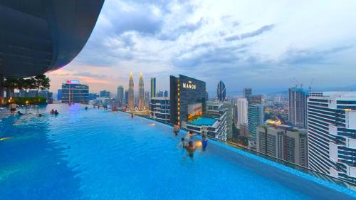 a swimming pool on the roof of a building at Eaton Residence KLCC - KL SUITE in Kuala Lumpur