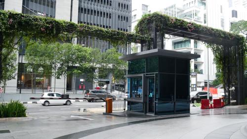 a phone booth on a city street with cars at Eaton Residence KLCC - KL SUITE in Kuala Lumpur