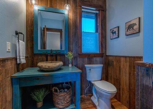a bathroom with a blue sink and a toilet at Emigrant Peak Lodge in Pray