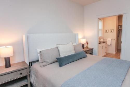 a white bedroom with a bed with two pillows at Yellowstone Flats in Livingston