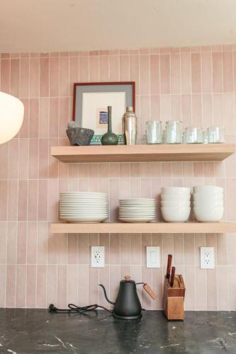 a kitchen with shelves with dishes and a tea kettle at The Holiday Rambler in Livingston