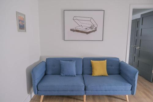 a blue couch with two yellow pillows in a living room at The Holiday Rambler in Livingston